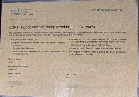 My Cisco Networking Academy course completion certificate for CCNA Routing and Switching: Introduction to Networks, with the instructor's name and signature blurred