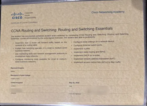 My Cisco Networking Academy course completion certificate for CCNA Routing and Switching: Routing and Switching Essentials, with the instructor's name and signature blurred